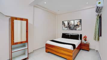 Un dormitorio con cama, armario, mesita de noche y decoración en la pared.