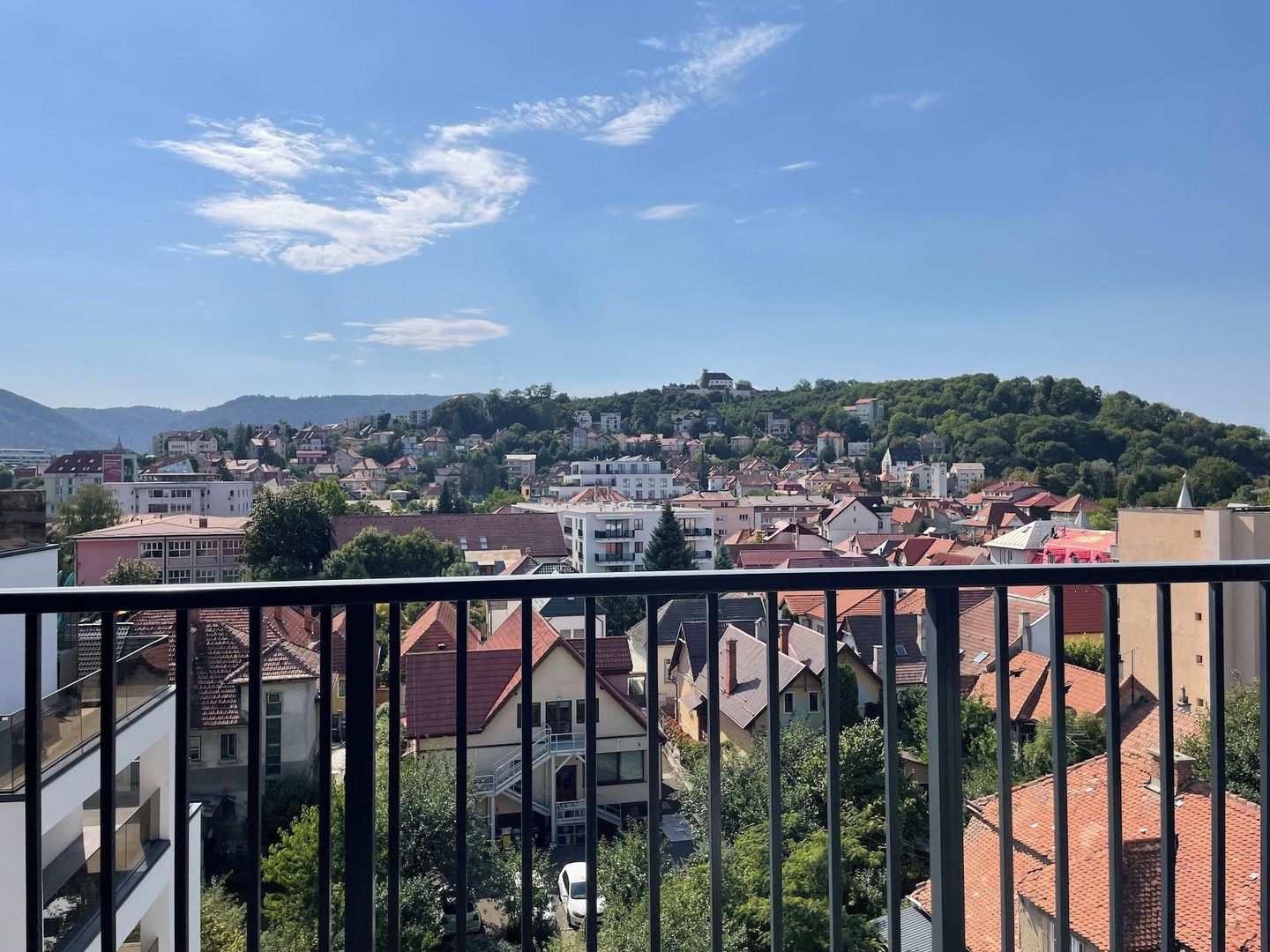A residential area with a view of a hill and a castle-like structure.