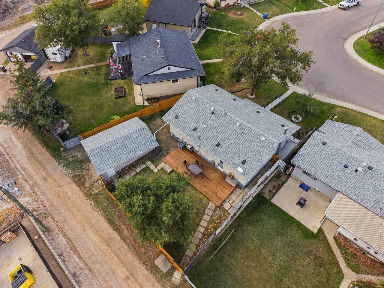 A residential area with multiple houses, a driveway, and a road.