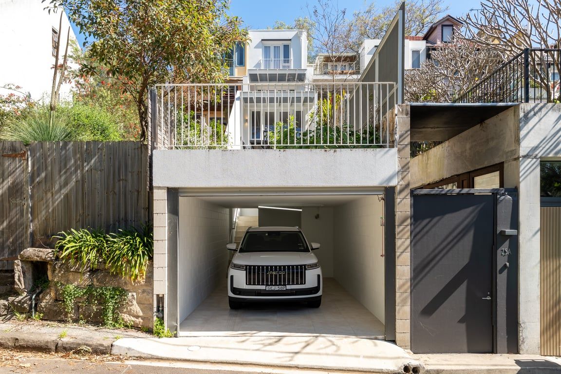 A modern two-story building with a covered parking area.