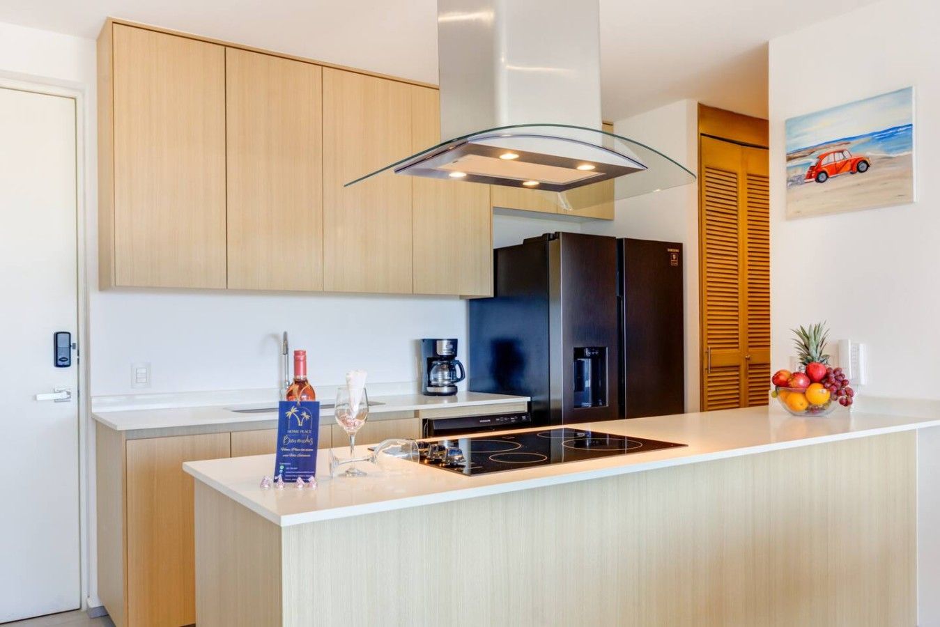 A modern kitchen with a central island, wooden cabinets, a black refrigerator, and a coffee machine.
