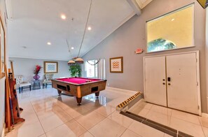 A pool table in a room with a white door, a framed picture on the wall, and a ceiling light fixture. - La Rosa Estate: Hacienda Getaway w/ Indoor Pool, Jacuzzi & Vintage Billiards (Las Vegas)