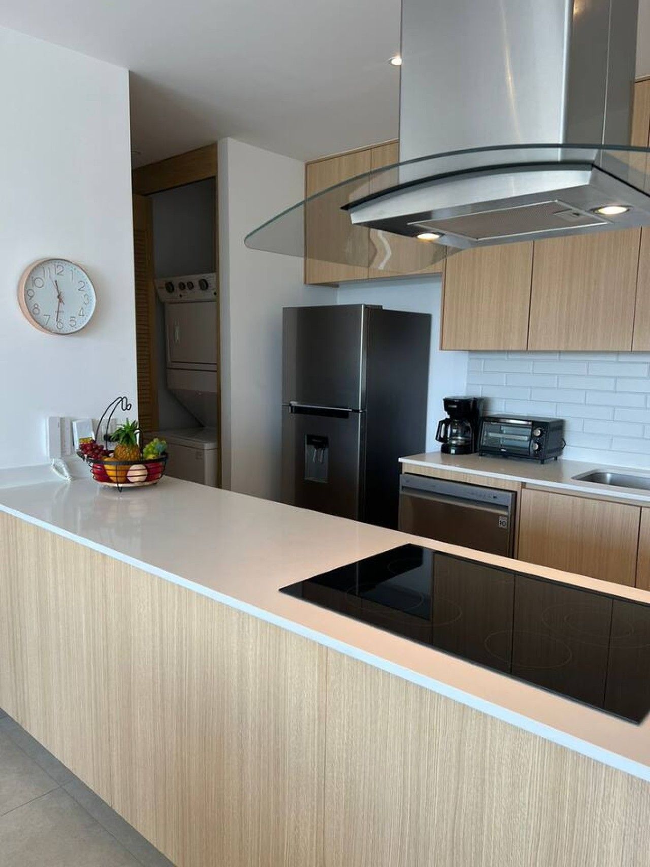 A modern kitchen with a stainless steel refrigerator, a built-in dishwasher, and a microwave.