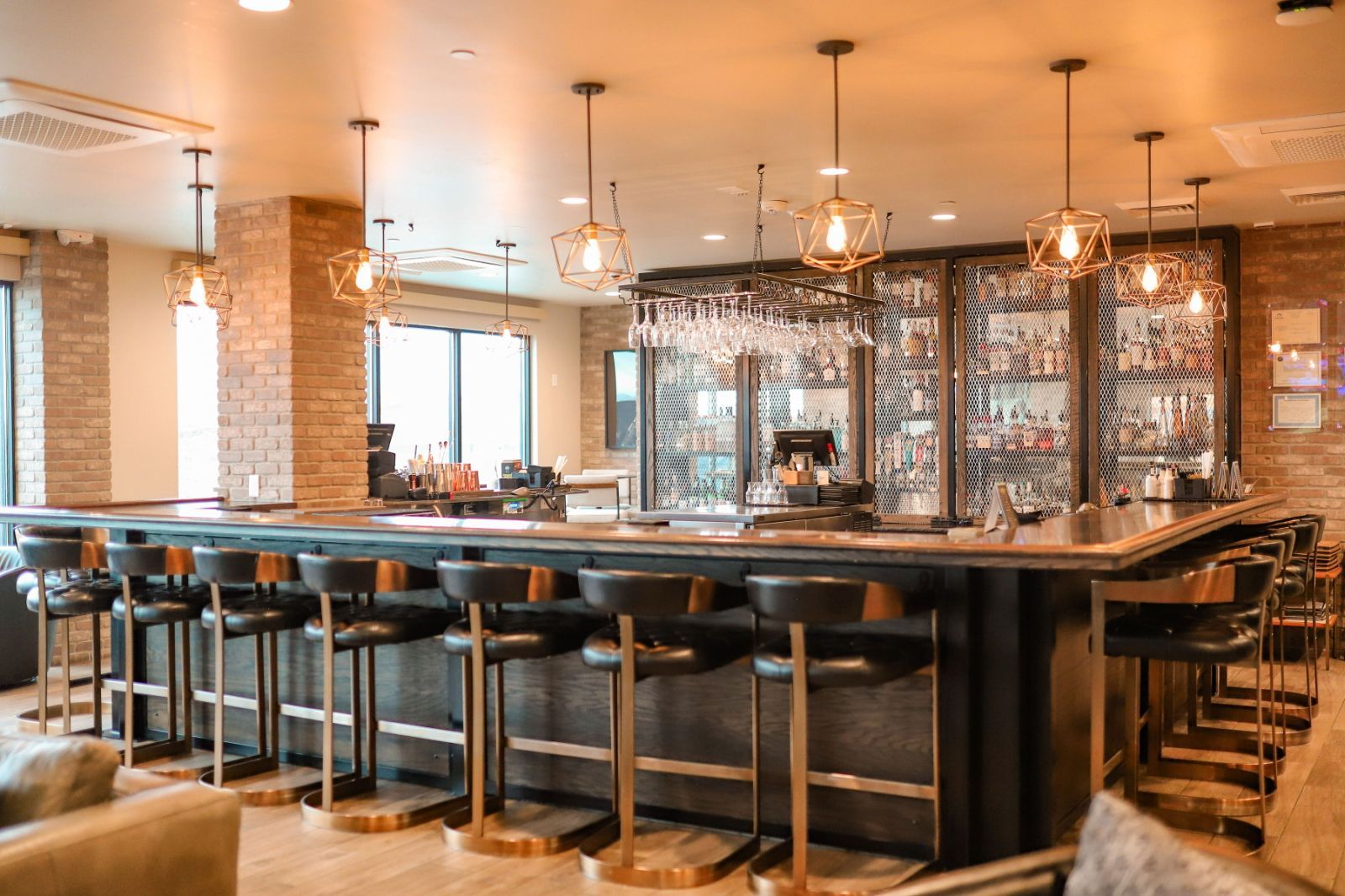 A bar area with multiple seating options, including bar stools and a high bar counter.