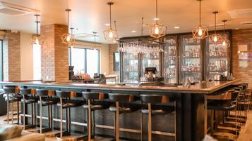 A bar area with multiple seating options, including bar stools and a high bar counter.