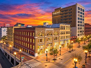 A multi-story building with a prominent sign for 'STERCHI'S' and 'EMPORIUM' on the ground floor. - Street View Condo | Walk to Knoxville’s Best (Knoxville)