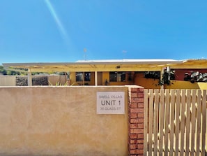A residential building with a sign indicating 'SWELL VILLAS UNIT 1 35 GLASS ST.' - Swell Villa 1 the perfect coastal escape (Kalbarri)