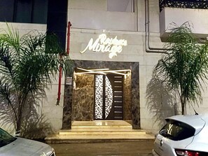 A building entrance with a sign that reads 'Mirage.'