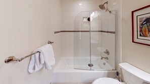 A modern bathroom with a glass-enclosed shower, a white bathtub, and a toilet. - Spruce Slopeside Ski-in Access (Beaver Creek)