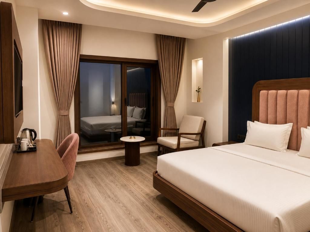 Une chambre d’hôtel avec un lit, un bureau, une chaise, une petite table et une fenêtre avec des rideaux.
