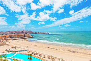 A coastal resort with a swimming pool, beachfront, and a view of the city. - Sonoran Star 1106-02 – Seaside Ocean View Paradise (Puerto Peñasco)