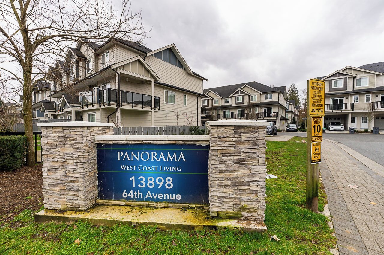 A residential area with a sign for Panorama West Coast Living at 13898 64th Avenue.