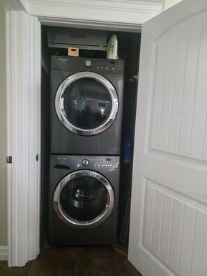 A compact, two-door laundry room with a built-in washer and dryer.