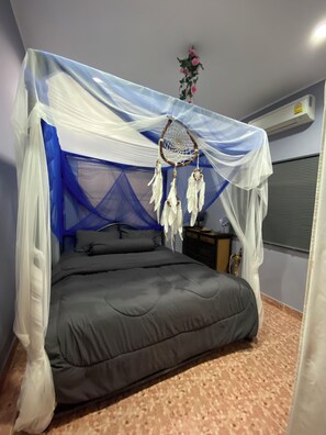 A bed with a canopy, a bedside table, and a wall-mounted air conditioner. - Wake up by the Sea in Phuket (Phuket)