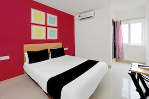 A hotel room with a bed, a red wall, and a window with curtains. - Hotel O Netaji Park Hyderabad Formerly (Hyderabad)