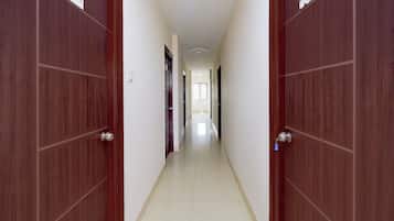 Un corridoio con porte in legno, ognuna contrassegnata da un numero.