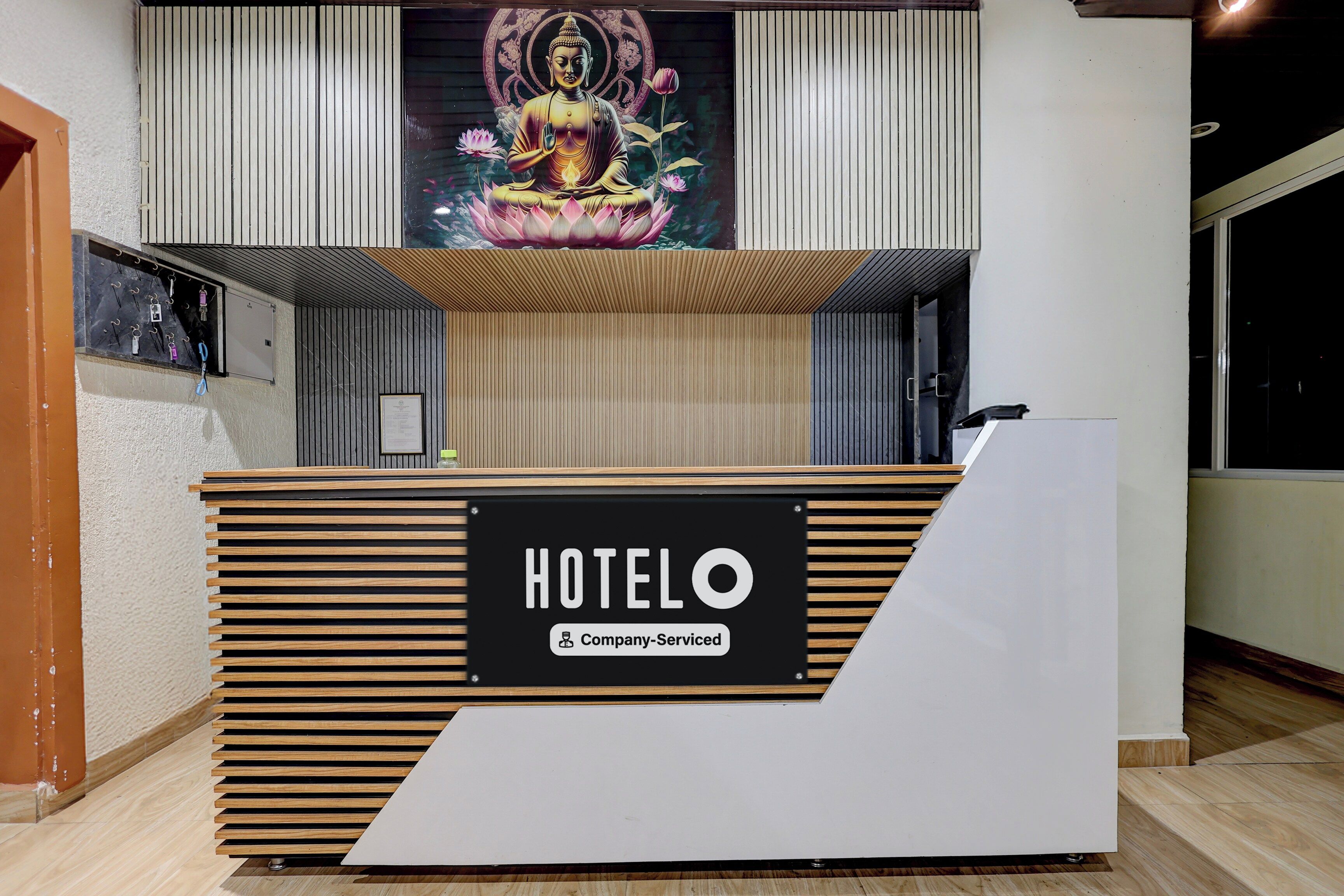 A hotel reception desk with a 'HOTELO' sign and a 'Company-Serviced' label.