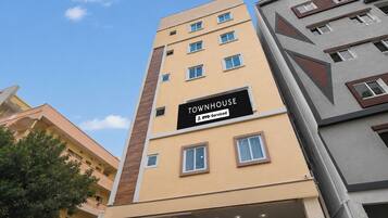 A multi-story building with a sign indicating it is serviced by OYO.