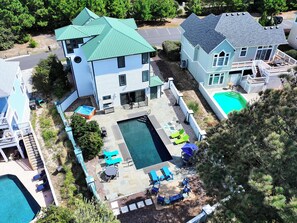 A residential property with a swimming pool, outdoor seating, and a covered patio area. - Soundside- Private Pool, Comm Amenities-MS842, Bella Vita OBX (Corolla)