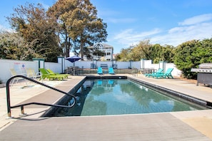 A swimming pool with a diving board, surrounded by lounge chairs and a barbecue grill. - Soundside- Private Pool, Comm Amenities-MS842, Bella Vita OBX (Corolla)