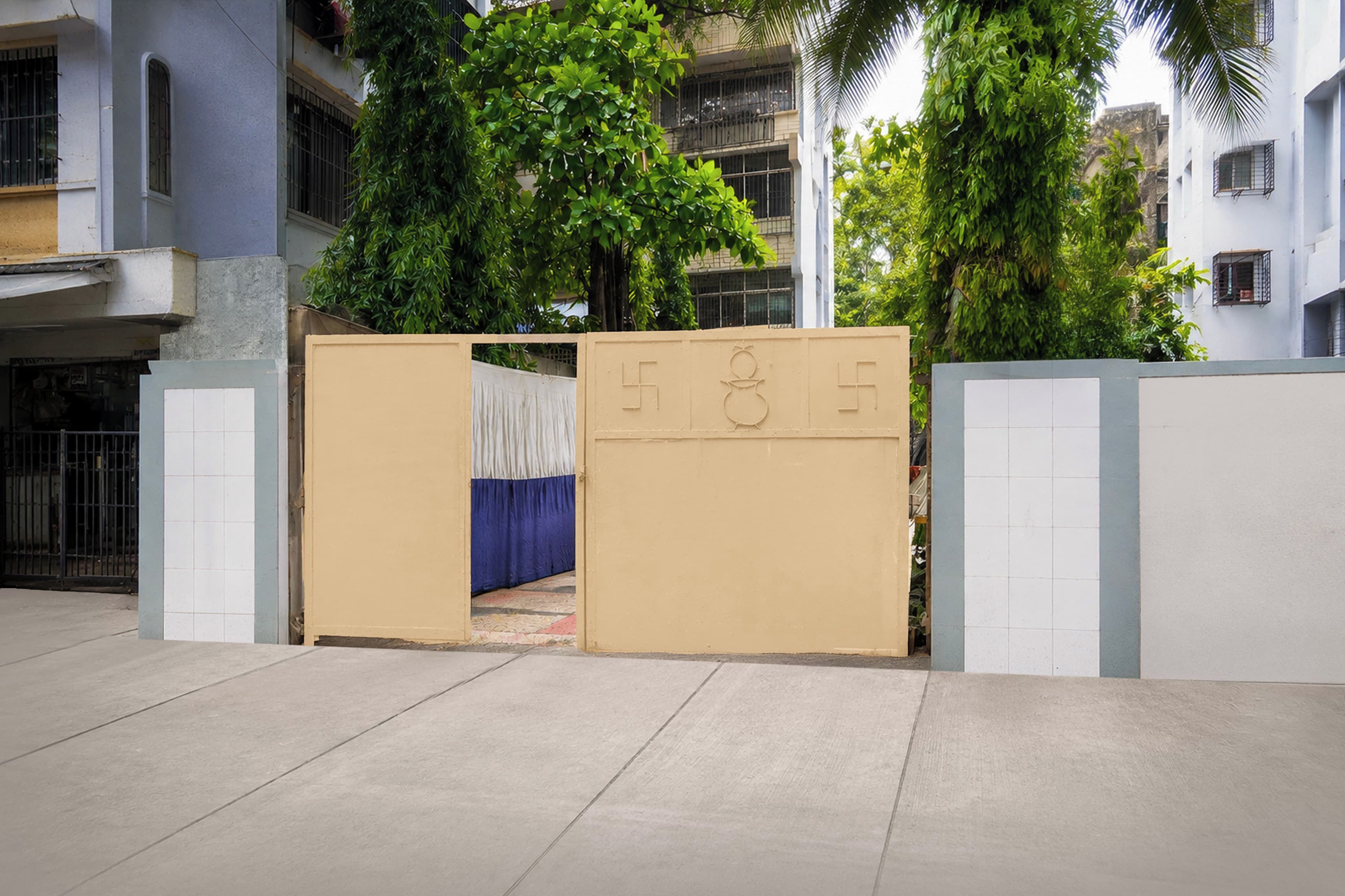 A gated entrance with a beige door and a blue curtain.