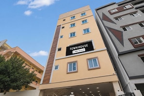 A multi-story building with a sign indicating it is serviced by OYO. - Collection O Deepor Beel (Guwahati)