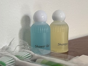 Two toiletry bottles labeled 'Shower Gel' and 'Shampoo' on a bathroom counter. - The Han Angkor Hotel (Siem Reap)
