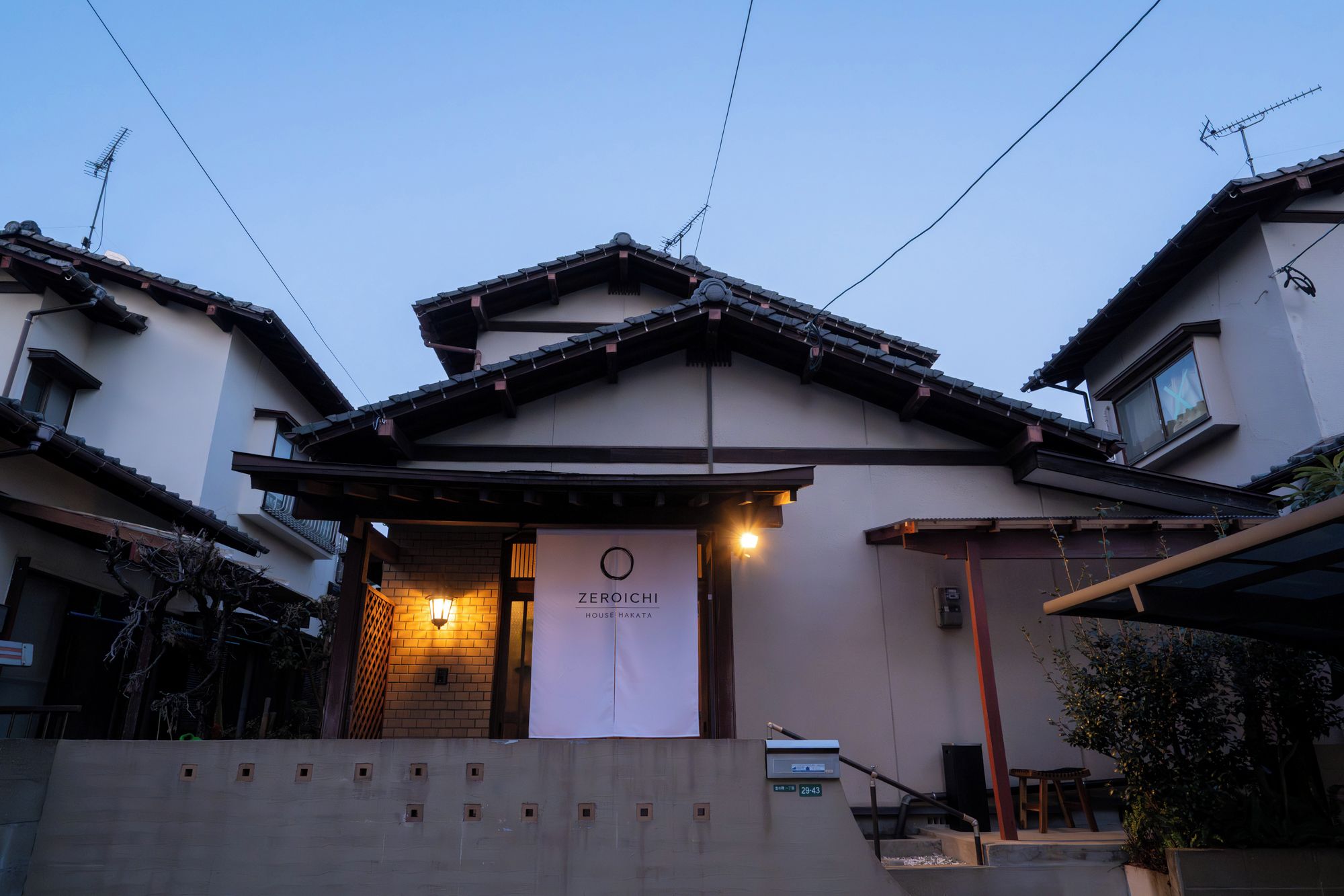A traditional Japanese building with a sign for Zenshoji, a house museum.