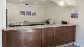 A kitchen with wooden cabinets, a countertop, and a ceiling with recessed lighting.