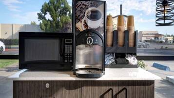 A coffee machine with a coffee cup and coffee beans on display.