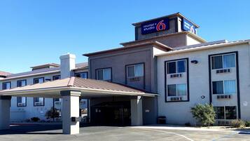 A modern building with a sign indicating it is a motel and studio.