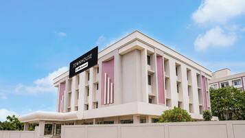 A modern building with a sign indicating it is serviced by OYO.