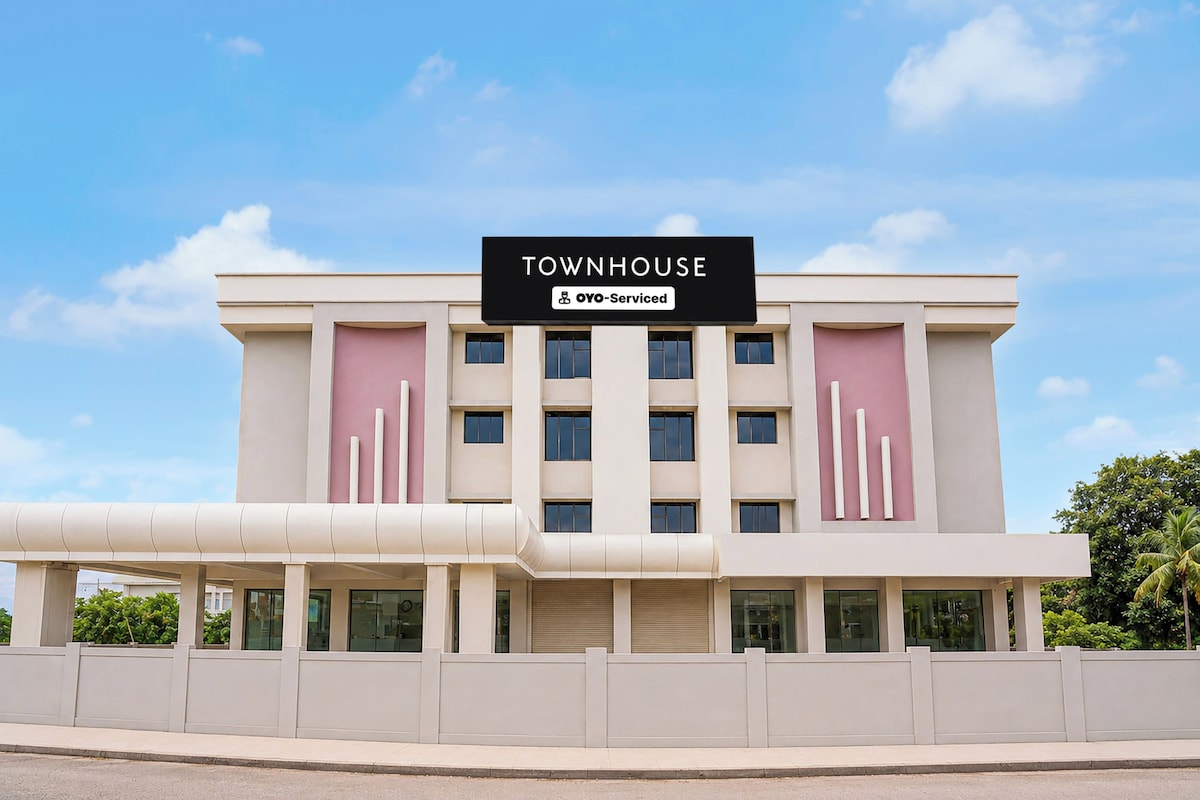 A multi-story building with a sign reading 'TOWNHOUSE' and 'YOYO-Serviced'.