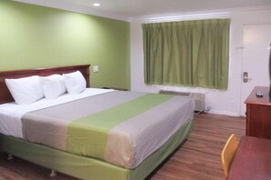 A hotel room with a bed, a desk, and a window with curtains. - 1 King Bed|Mobility|Tub,Nsmk (Fresno CA)
