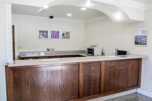 A kitchen with a wooden countertop and cabinets, a built-in oven, and a wall-mounted security camera. - 1 King Bed|Mobility|Tub,Nsmk (Fresno CA)