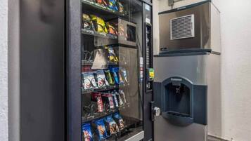 A vending machine stocked with snacks and a water dispenser.