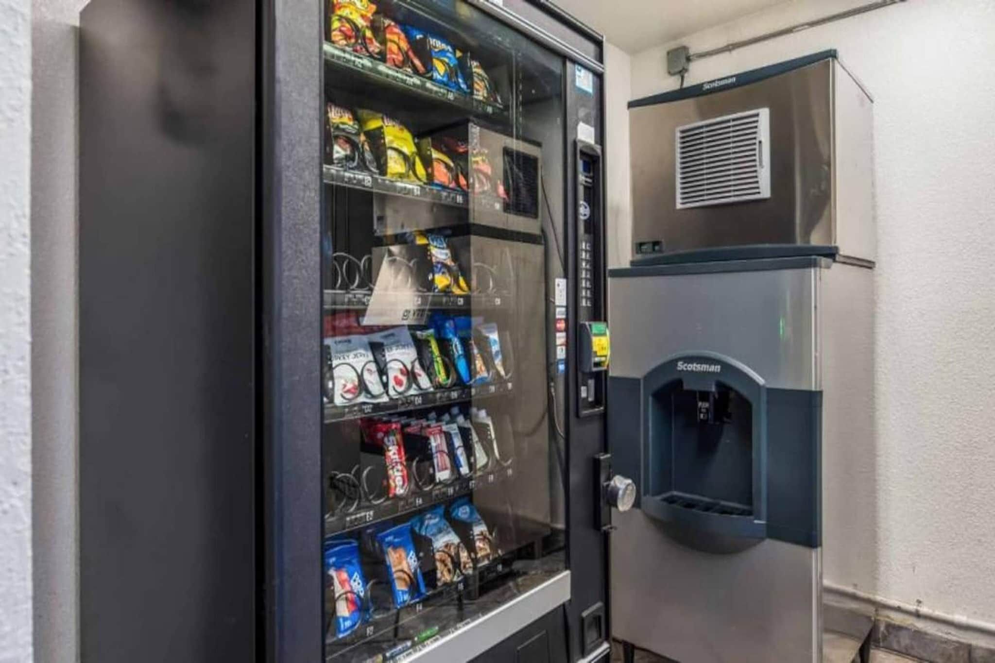 A vending machine stocked with snacks and a water dispenser.