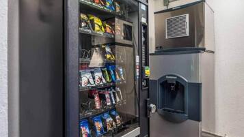 A vending machine stocked with snacks and a water dispenser.