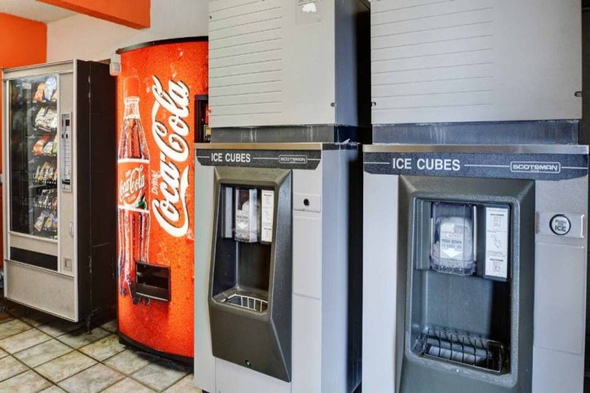 Vending machines with Coca-Cola branding and ice cube dispensers.
