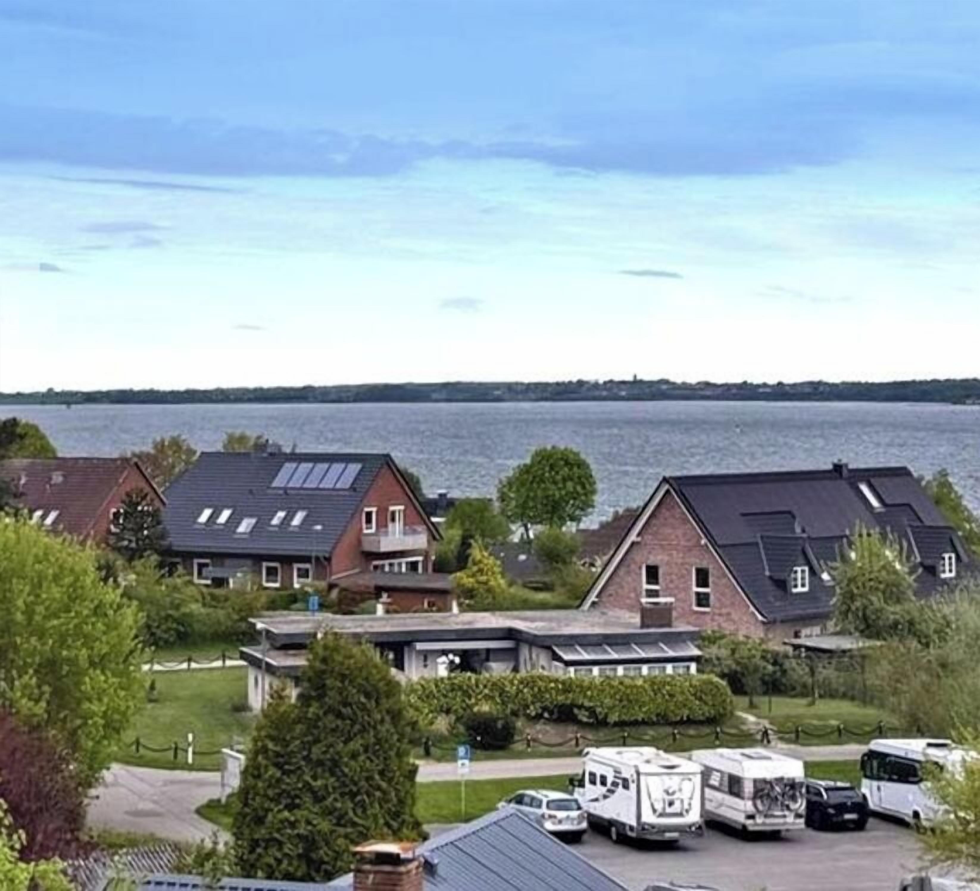 Een woonwijk met huizen en een parkeerplaats met campers.