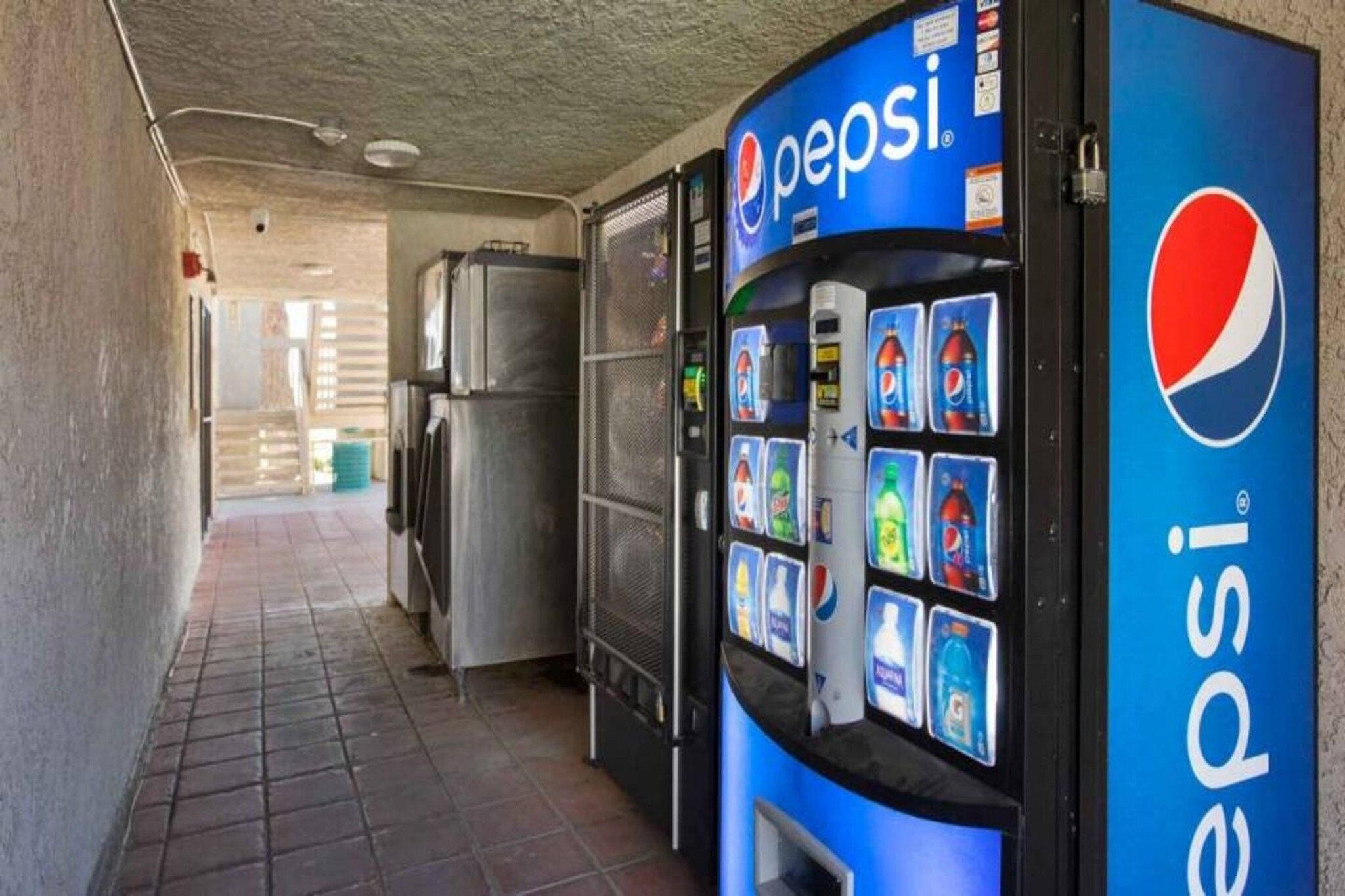 A vending machine with Pepsi branding and a selection of beverages.