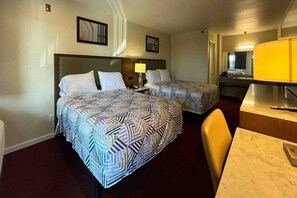 A hotel room with two beds, a desk, a chair, and a mirror. - 2 Queen Beds | Non-Smoking, Micfridge (Santa Ana)