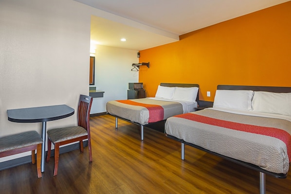 A hotel room with two beds, a small table, a chair, and a microwave. - 2 Full Beds | Smoking, Micfridge (Hesperia)