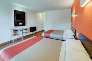 A hotel room with two beds, a desk, a chair, and a television. - 2 QUEEN BEDS | MICFRIDGE (SANTA ANA)