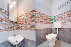 Un baño con lavabo, inodoro y zona de ducha.