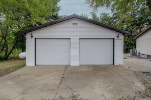 A two-car garage with a gable roof and a concrete driveway.