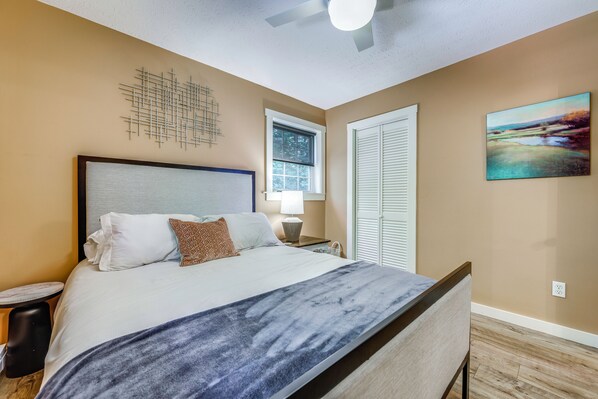 A bedroom with a bed, a window, a painting, and a ceiling fan. - Cold Mountain Cabin w/Hot Tub, Pool Table & Views (Canton)
