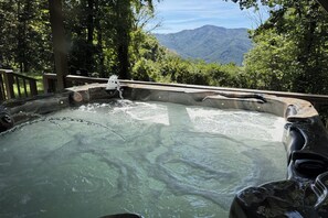 A hot tub with a view of mountains in the background. - Cold Mountain Cabin w/Hot Tub, Pool Table & Views (Canton)