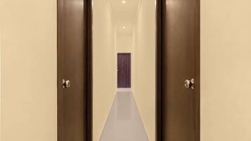 Un pasillo con dos puertas que conducen a una habitación con una puerta morada.