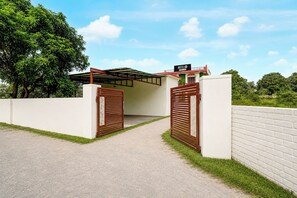 A gated entrance to a building with a sign indicating it is a hotel. - Hotel O Sahaspur Dehradun (Vikasnagar)